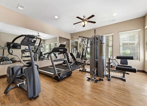 A spacious home gym with a variety of exercise equipment.
