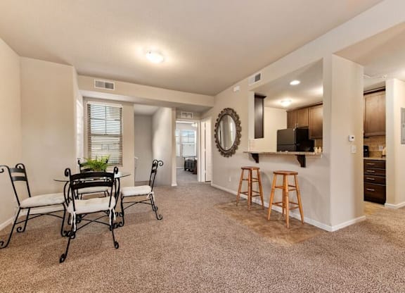 A living room with a dining table and chairs.