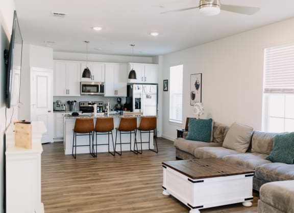 a living room with a kitchen and a couch and a table