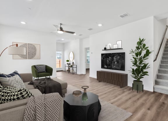 a living room with white walls and hardwood flooring