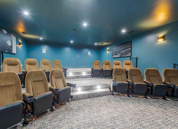 A row of seats in a room with blue walls.