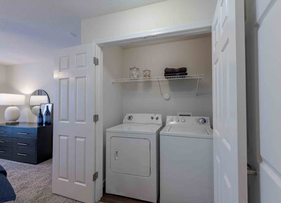A white laundry room with a washer and dryer.