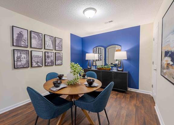 A dining room with a wooden table and blue chairs.