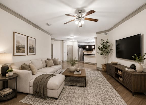 A living room with a white couch and a ceiling fan.