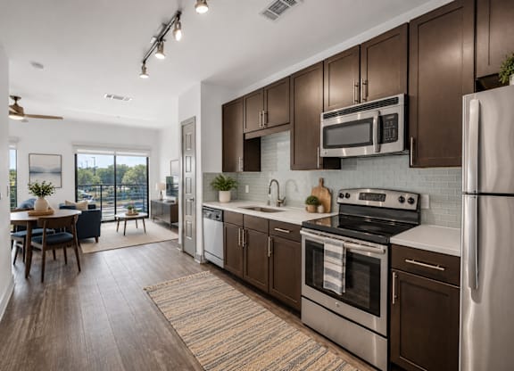 A kitchen with stainless steel appliances at Markethaus 3700 in Plano Texas