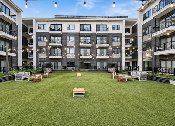 A large grassy area in front of buildings at Markethaus 3700 in Plano Texas