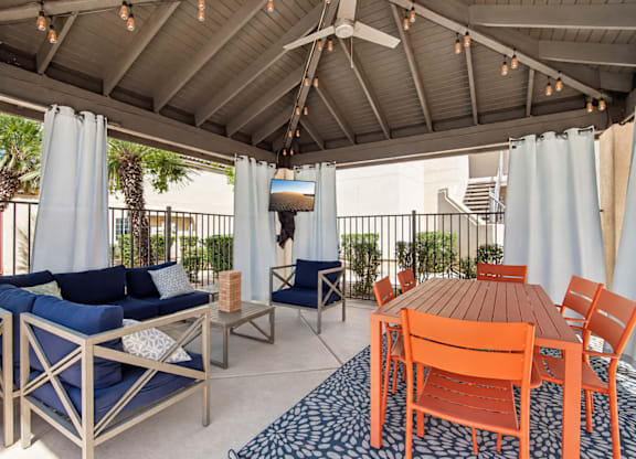 A patio with a table and chairs.