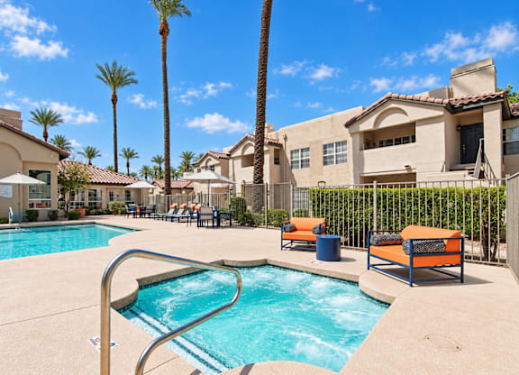 A pool area with a slide and sun loungers.