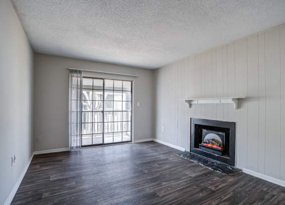 A room with a fireplace and a window.