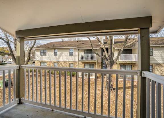A view from a balcony looking at apartment buildings.
