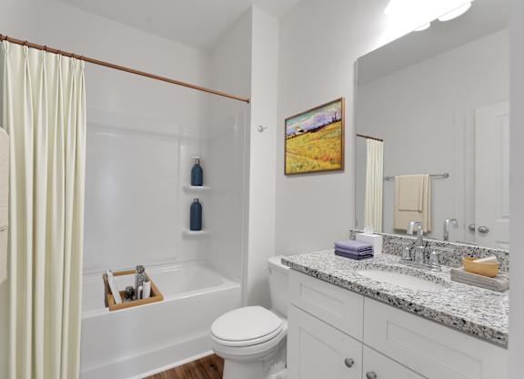 A bathroom with a toilet, sink, and bathtub.