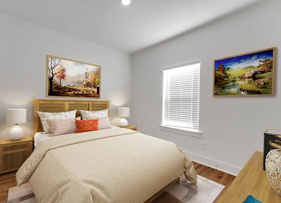 A bedroom with a large bed and two pictures on the wall.