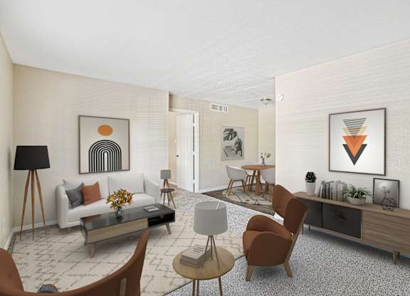 A living room with a white couch, a coffee table, and a few chairs.