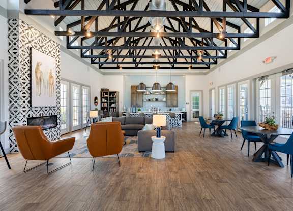 A living room with a fireplace and a dining table.