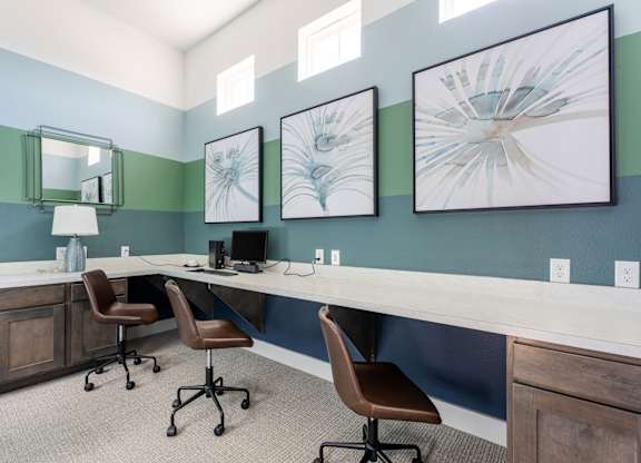 A room with a desk and chairs.