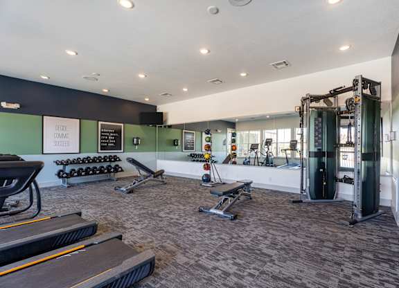 A gym with treadmills, weights, and exercise equipment.
