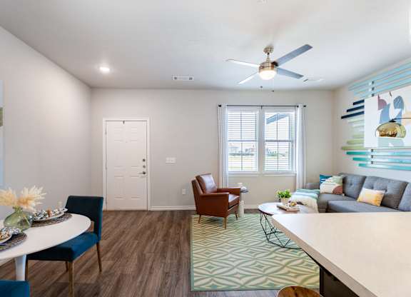 A living room with a dining table and chairs.