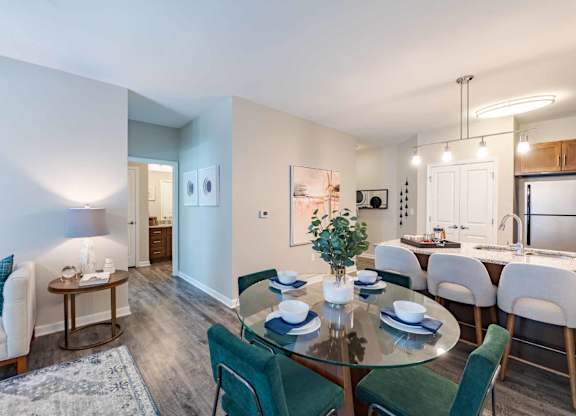 A dining room with a glass table and chairs.