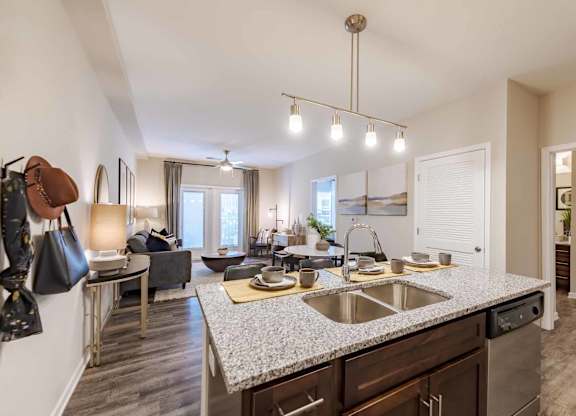 A kitchen with a granite countertop and a sink.
