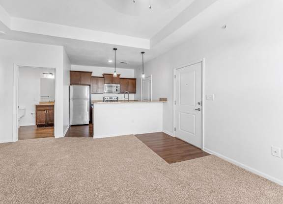 A kitchen with white walls and brown cabinets.