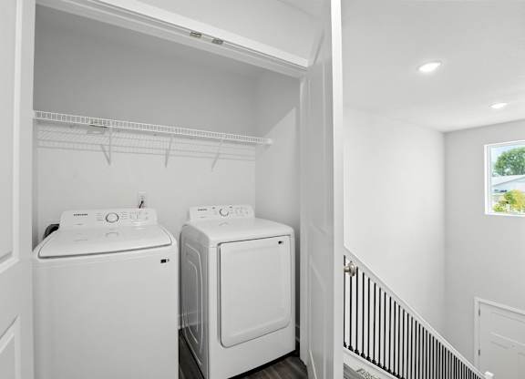 A white laundry room with a washer and dryer.