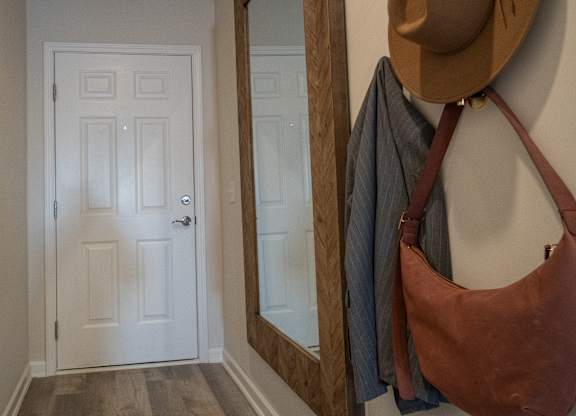 A white door with a mirror above it.