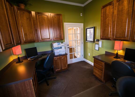 A room with green walls and wood cabinets.