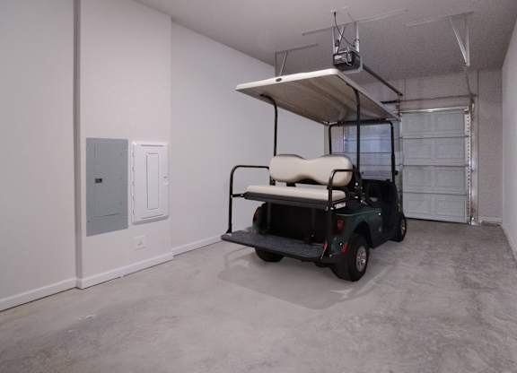 A golf cart is parked in a garage.