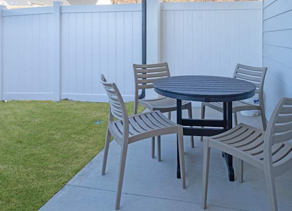 A table and chairs set up on a patio.