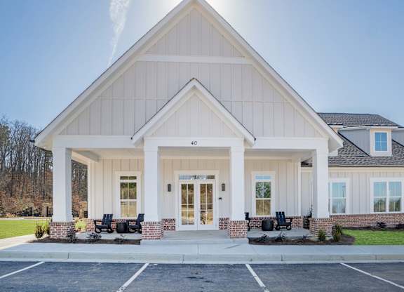 A church with a white facade and a large front porch.