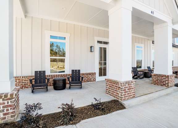 A house with a porch and a brick column.