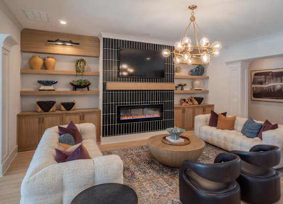 A living room with a fireplace and a chandelier.