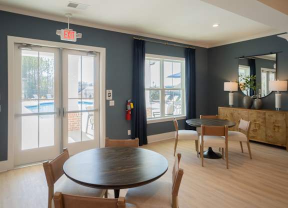 A dining room with a round table and chairs.