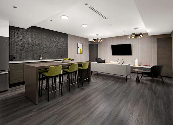 A modern kitchen with a bar area and seating.