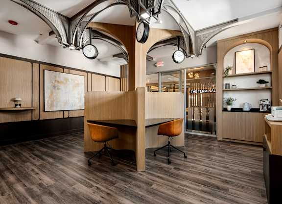A modern office space with wood floors and furniture.
