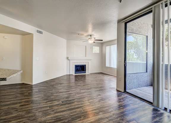 A spacious living room with a fireplace and sliding glass doors.