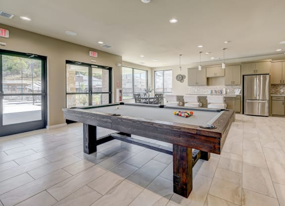 Pool table in resident clubhouse with entertainment kitchen