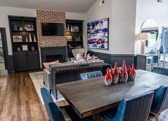 A dining room with a wooden table and chairs.