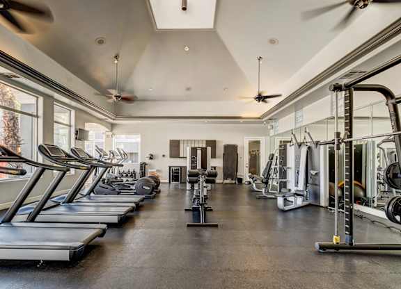 A spacious gym with treadmills and other exercise equipment.