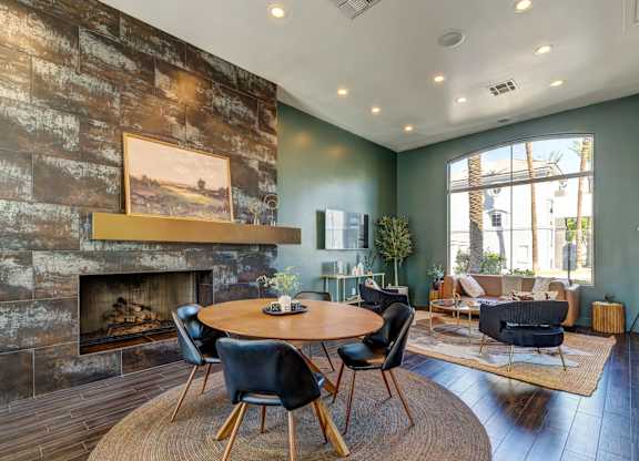 A living room with a fireplace and a painting on the wall.
