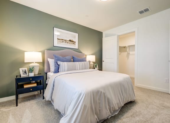 Bedroom with walk-in closet and large windows