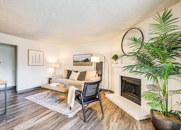 A living room with a fireplace and a chair.