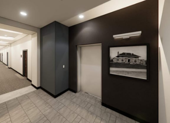 A long hallway with doors on both sides and a picture on the wall.