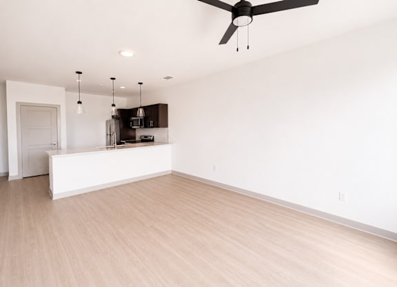 A room with a ceiling fan and light fixture.
