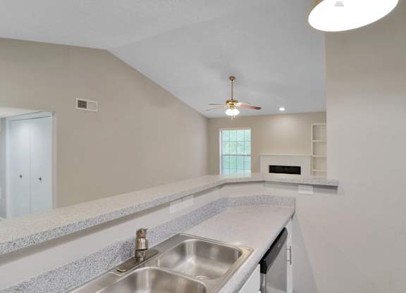 A kitchen with a sink and a window.