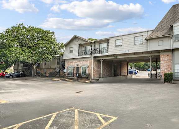 A parking lot with a building in the background.