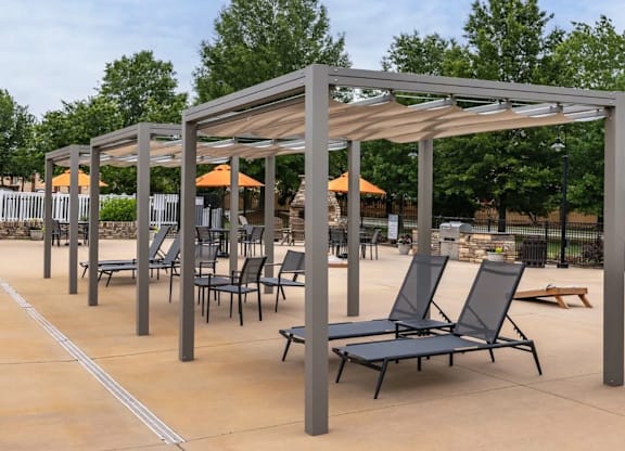 A patio with a canopy and chairs.