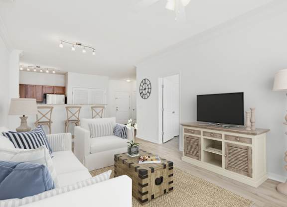 A living room with a white couch, a wooden cabinet, and a television.