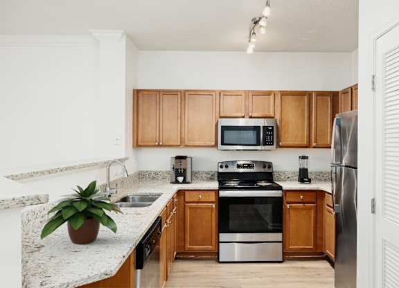 A kitchen with wooden cabinets and stainless steel appliances.
