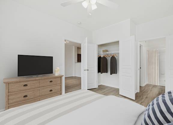 A bedroom with a bed, dresser, and a television.